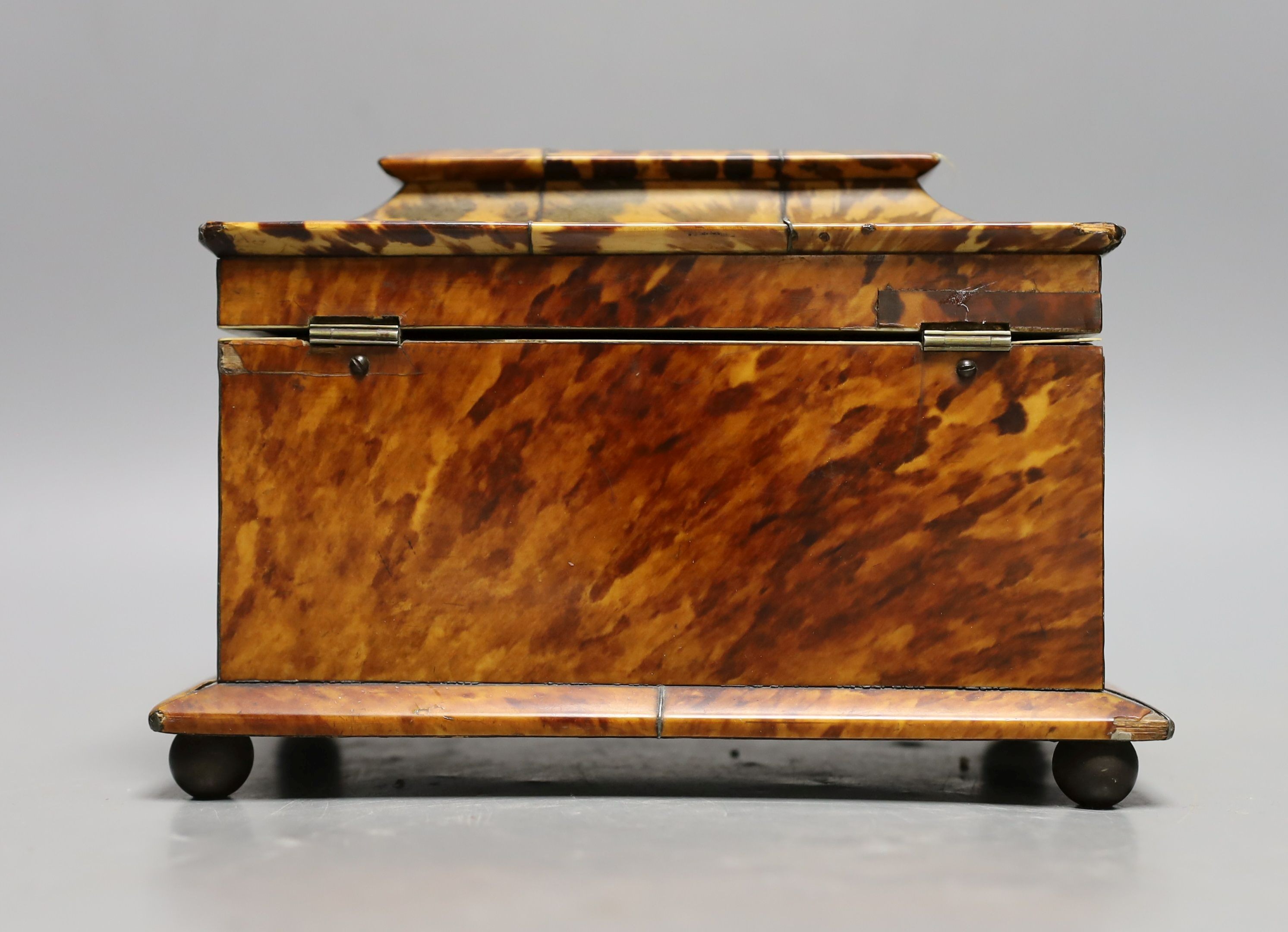 A 19th century tortoiseshell veneered tea caddy, ivory veneered edging, 20cms wide